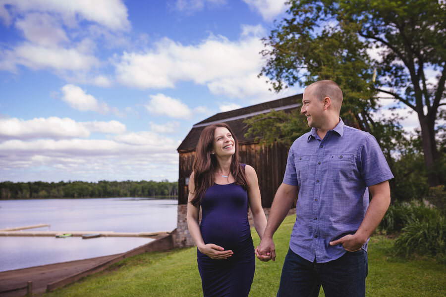 Beautiful maternity photography of a husband and wife walking during their photoshoot in the park