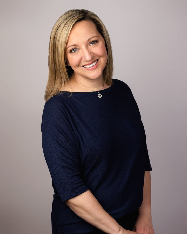 Smiling woman posing for her professional headshots in studio