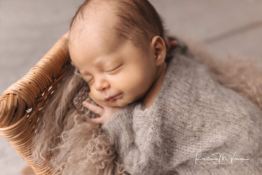 Closeup of sleeping newborn boy in brown pajamas during his photoshoot