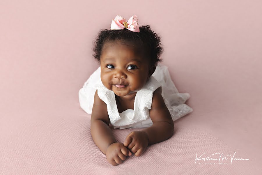 Smiling black baby girl posing during her princess baby photos by The Flash Lady Photography