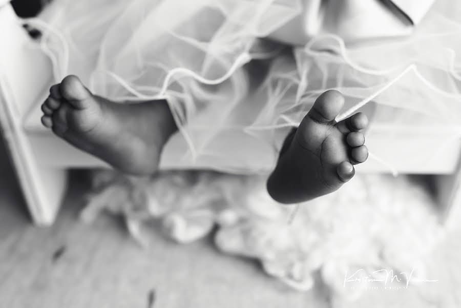 Closeup black and white photo of a black baby girl's cute toes during her photoshoot