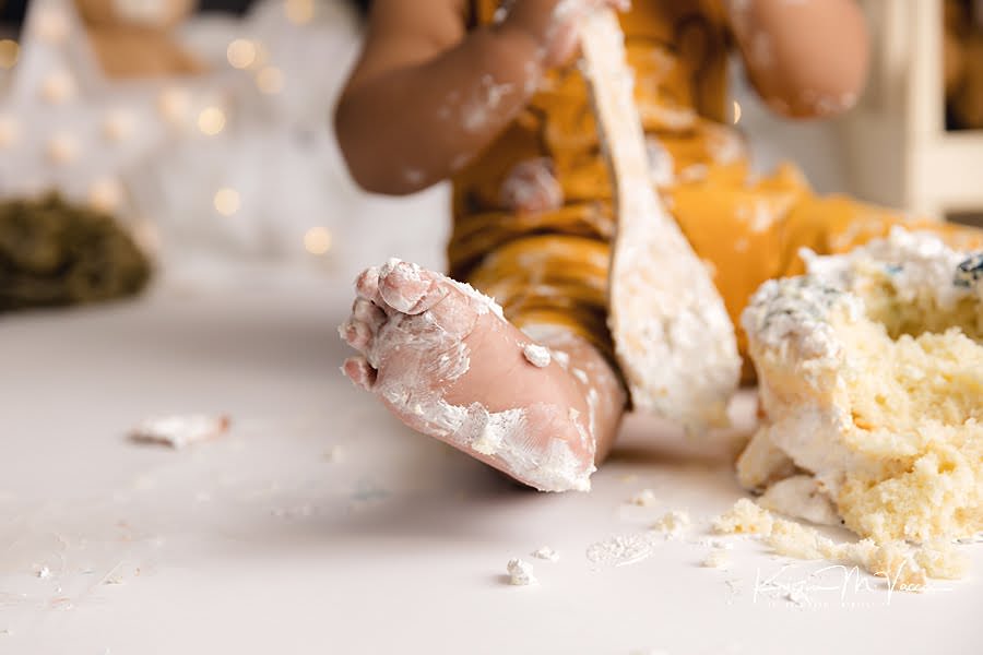 Close up of a baby boy's frosting covered foot during his cake smash