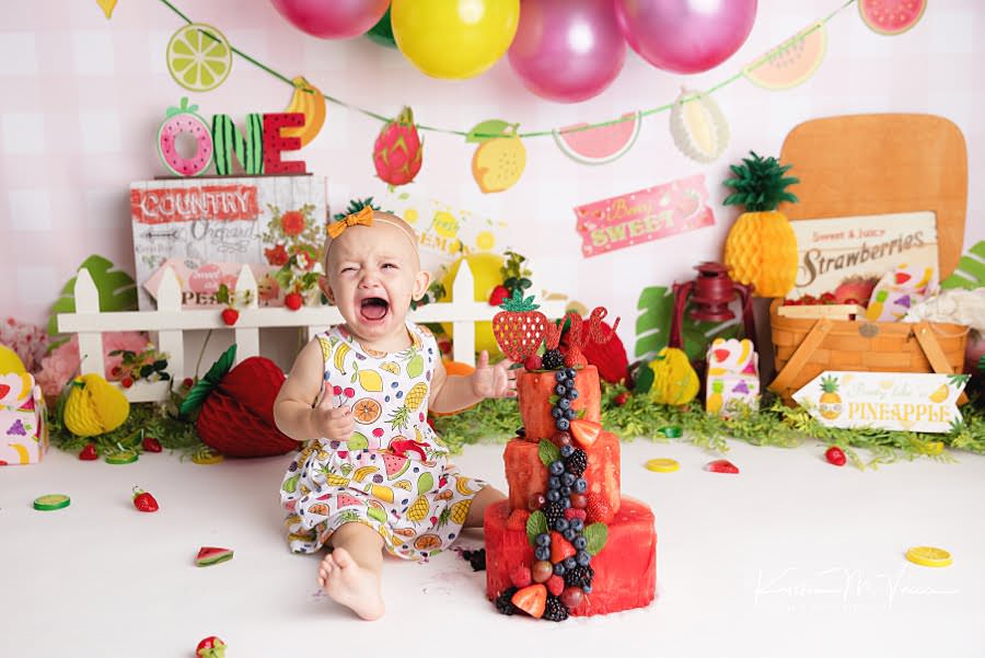 Toddler girl cries during her cake smash photoshoot