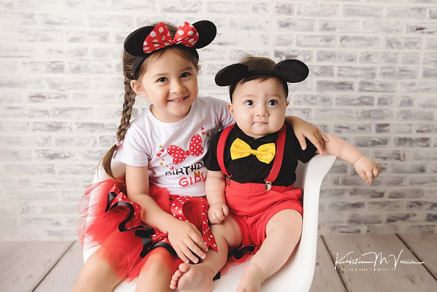 Sister and brother pose together in red mickey outfits during their birthday photoshoot