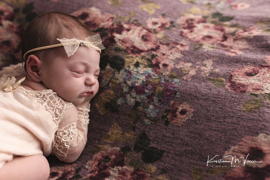 Above image of a sleeping baby girl during her newborn photoshoot