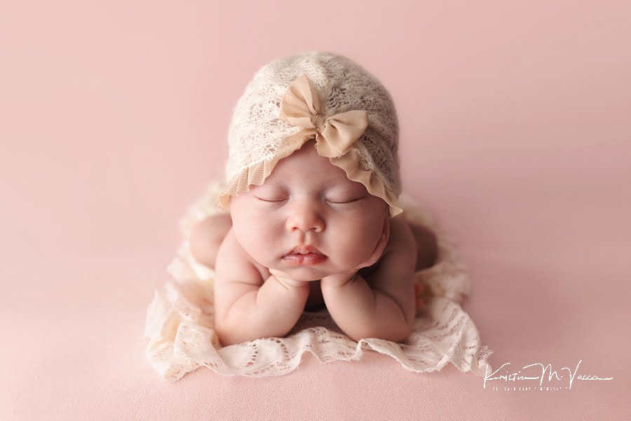 Sleeping baby in froggie pose during her pretty in pink newborn photos