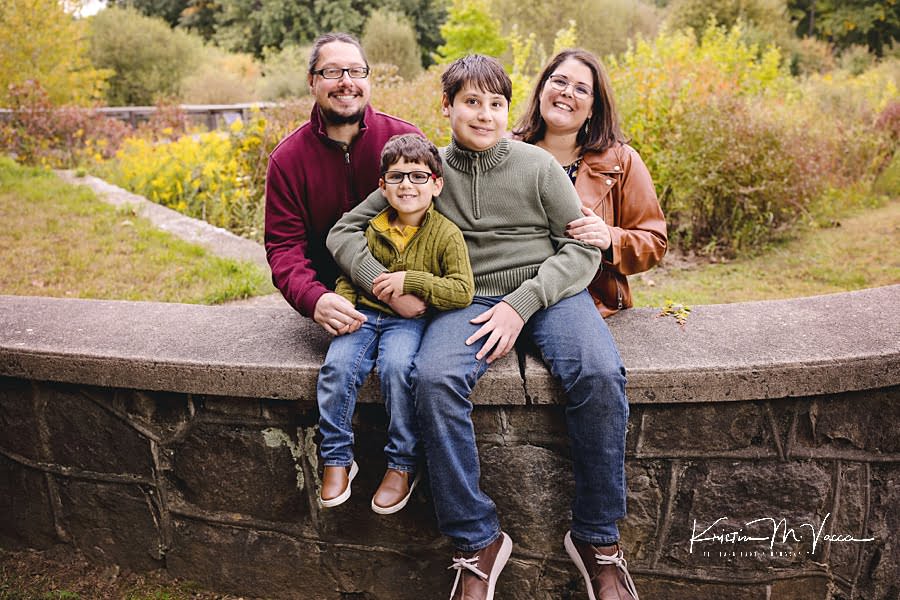 Family of 4 poses for the camera during their early fall family photos