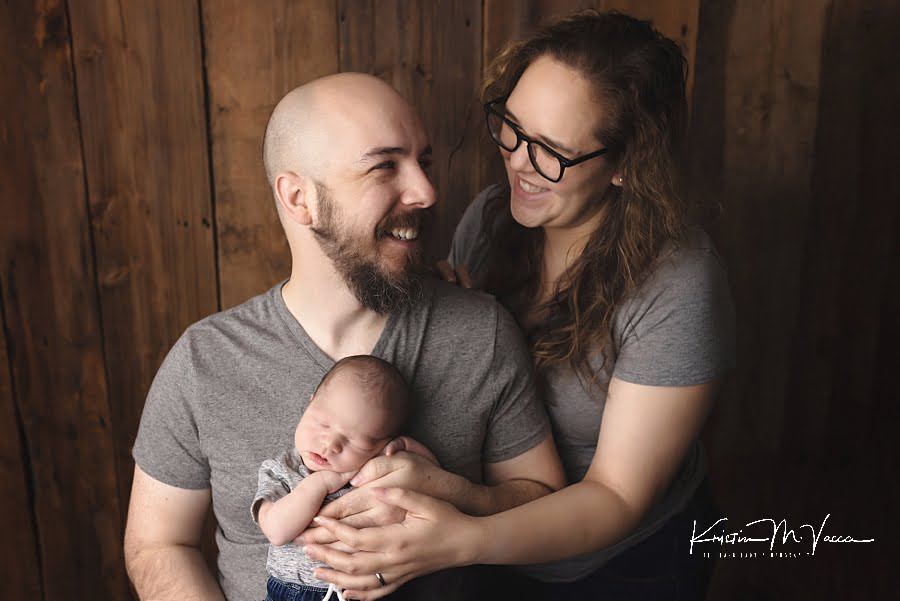 Mom & Dad smile at each other during their newborn photoshoot