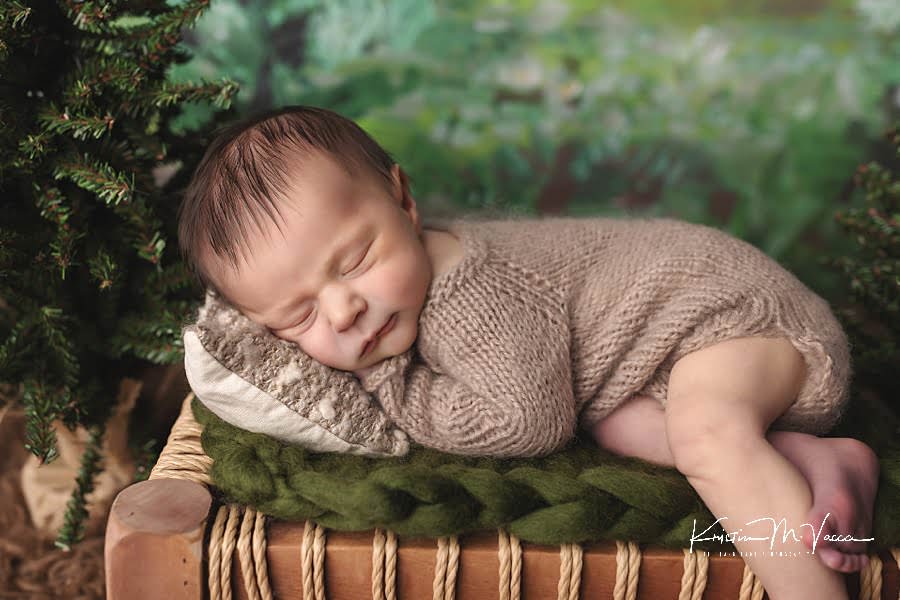 Sleeping baby on a green blanket during his fall woodland newborn photos
