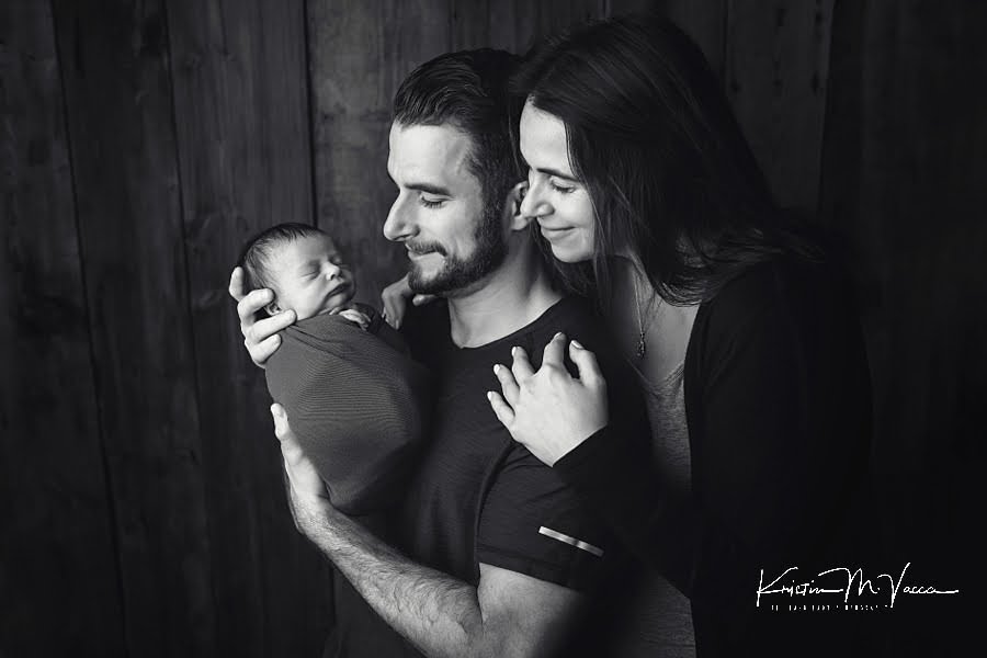 Black and white photo of Mom & Dad looking at their baby boy during their fall woodland newborn photos