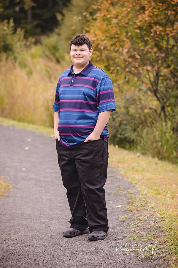 Teen brother poses for his senior portraits