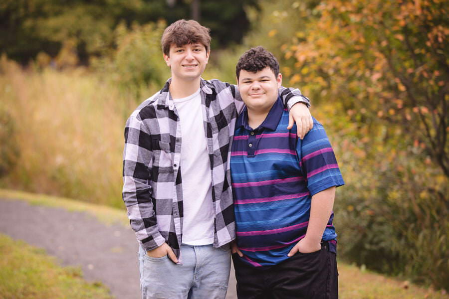 Twin brothers pose together during their senior photoshoot