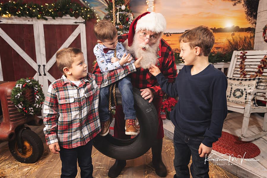 3 brothers pull Santa Claus’s beard during their Christmas photoshoot at The Flash Lady Photography